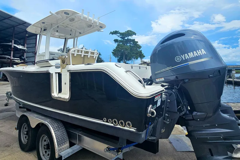 Slide: The Image of 2016 Sea Hunt Gamefish 25 boat with Yamaha engine on trailer. - 9