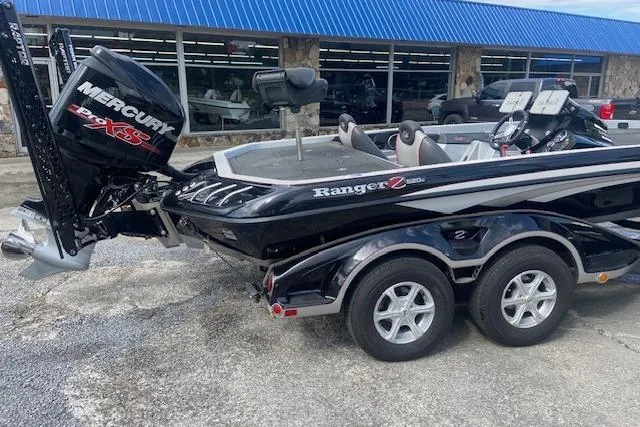 The Image of 2014 Ranger 520C boat with Mercury Pro XS engine, parked outside a store. - 0