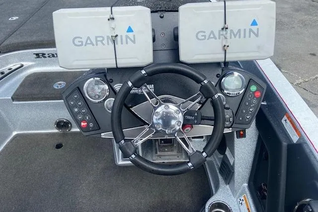 Slide: The Image of 2014 Ranger 520C boat dashboard with dual Garmin displays and steering wheel. - 3