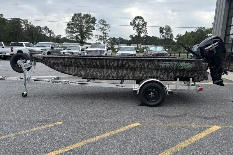 The Image of 2025 Havoc 1756 MRST boat on trailer, camo design, parked outdoors. - 1