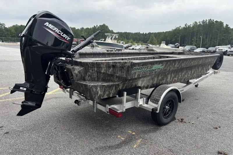 Slide: The Image of 2025 Havoc 1756 MRST boat with Mercury engine on trailer, parked outdoors. - 11