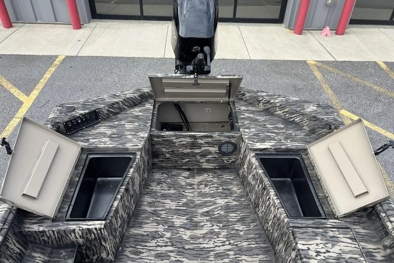 Slide: The Image of 2025 Havoc 1756 MRST boat with open storage compartments and camouflage design. - 6