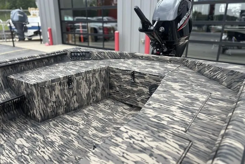Slide: The Image of 2025 Havoc 1756 MRST boat interior with camo design and Mercury outboard motor. - 9