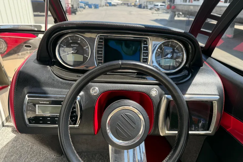 Slide: The Image of 2011 Malibu Wakesetter 23 LSV dashboard with steering wheel and instrument panel. - 11