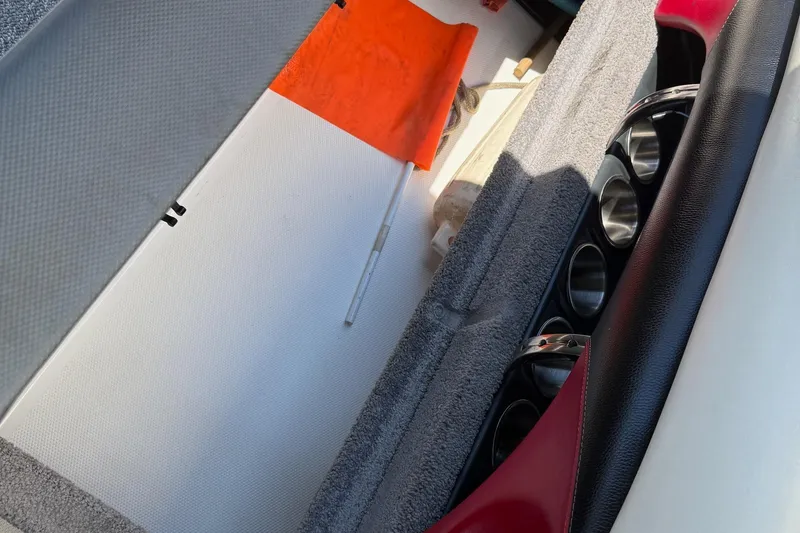 Slide: The Image of Interior storage of 2011 Malibu Wakesetter 23 LSV with safety equipment and cup holders. - 12