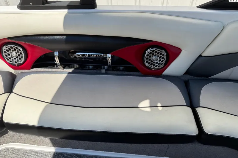 Slide: The Image of 2011 Malibu Wakesetter 23 LSV interior with red speakers and cushioned seating. - 14