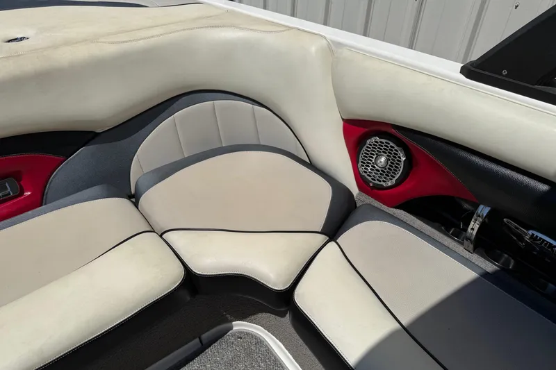 Slide: The Image of 2011 Malibu Wakesetter 23 LSV interior seating with red accents and speaker. - 15