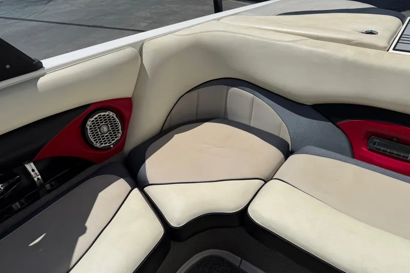 Slide: The Image of 2011 Malibu Wakesetter 23 LSV interior with beige and red seating, featuring a speaker. - 17