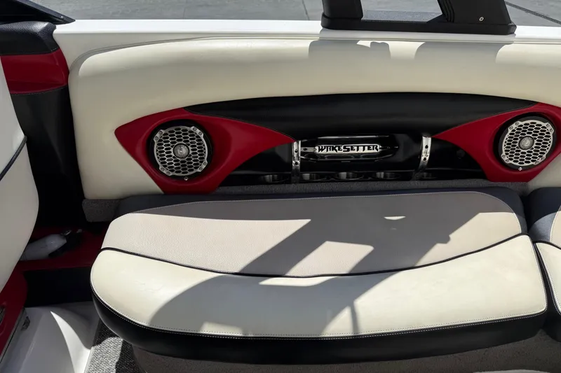 Slide: The Image of 2011 Malibu Wakesetter 23 LSV interior with red accents and speaker system. - 18