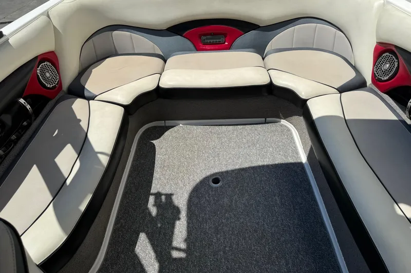 Slide: The Image of 2011 Malibu Wakesetter 23 LSV interior with cushioned seating and red accents. - 8