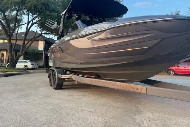 Slide: The Image of 2018 Centurion Fi23 boat on trailer, parked in residential area. - 11