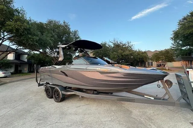Slide: The Image of 2018 Centurion Fi23 boat on trailer, parked in residential area. - 14