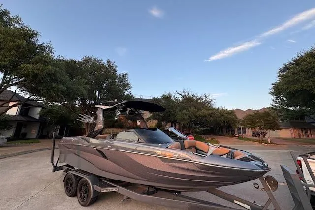 Slide: The Image of 2018 Centurion Fi23 boat on trailer in suburban neighborhood setting. - 15