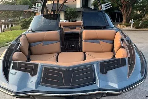 Slide: The Image of 2018 Centurion Fi23 boat with tan seating and sleek design, parked outdoors. - 16