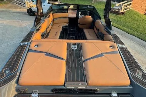 Slide: The Image of 2018 Centurion Fi23 boat with tan leather interior, spacious seating, and sleek design. - 5