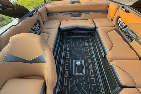 Slide: The Image of 2018 Centurion Fi23 boat interior with tan leather seats and branded flooring. - 7