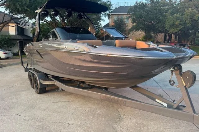 Slide: The Image of 2018 Centurion Fi23 boat on trailer, parked in residential area. - 9