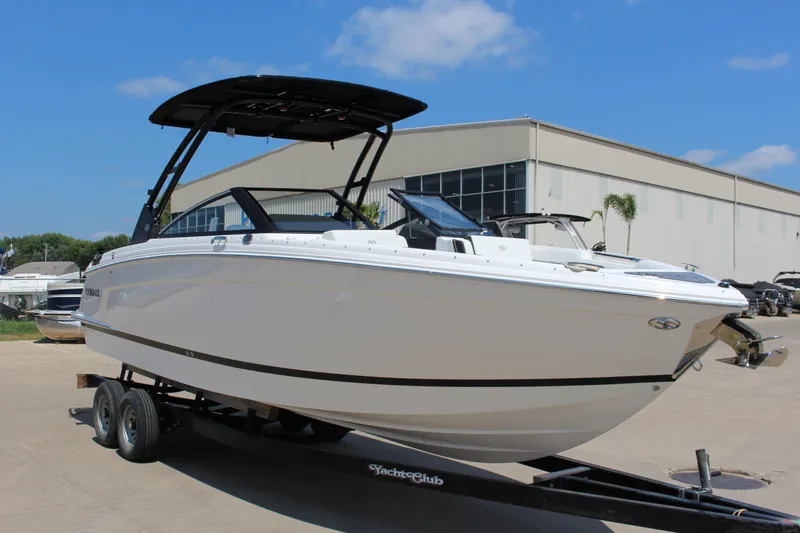 The Image of 2025 Cobalt R8 boat on trailer, displayed outdoors under clear blue sky. - 0