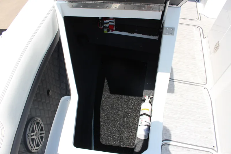 Slide: The Image of Storage compartment in 2025 Cobalt R8 boat with fire extinguisher and speaker. - 15