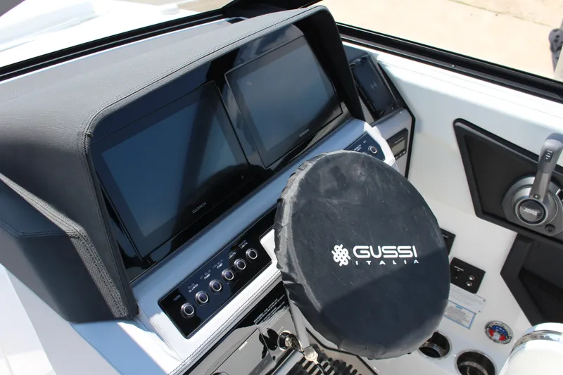 Slide: The Image of 2025 Cobalt R8 boat dashboard with dual Garmin screens and Gussi Italia steering wheel cover. - 19