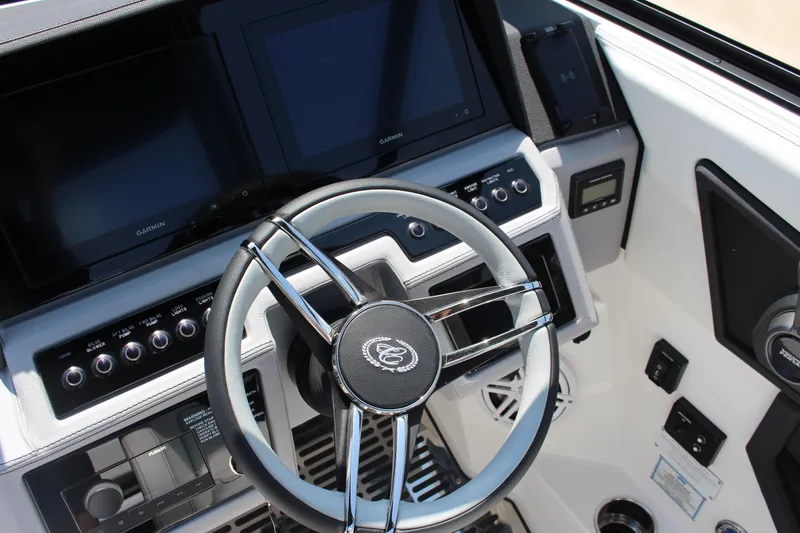 Slide: The Image of 2025 Cobalt R8 boat dashboard with steering wheel and digital displays. - 20