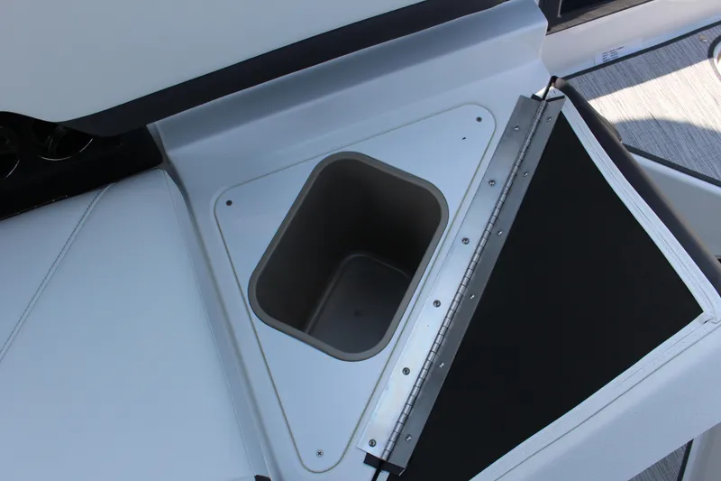 Slide: The Image of 2025 Cobalt R8 boat storage compartment with open lid, showcasing sleek design. - 24