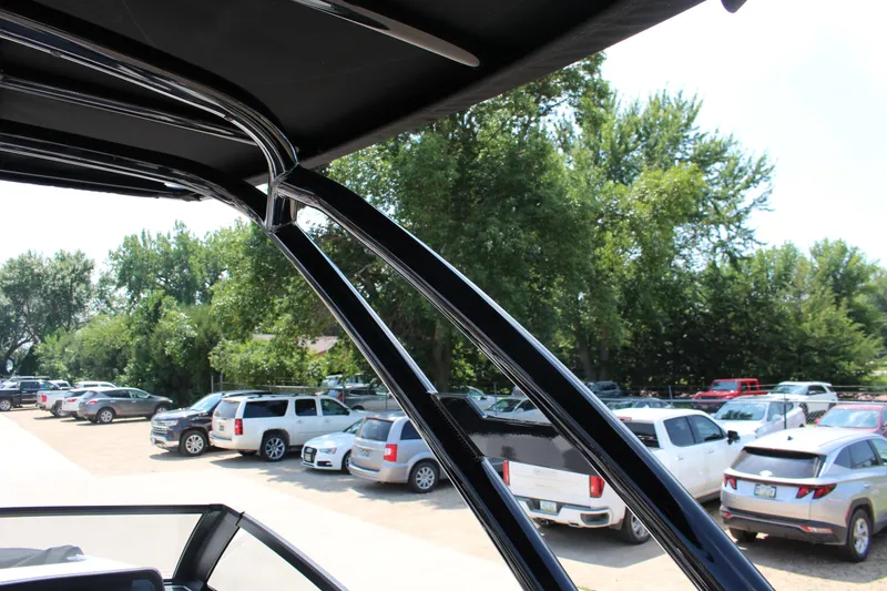 Slide: The Image of 2025 Cobalt R8 boat frame with parked cars and trees in the background. - 26