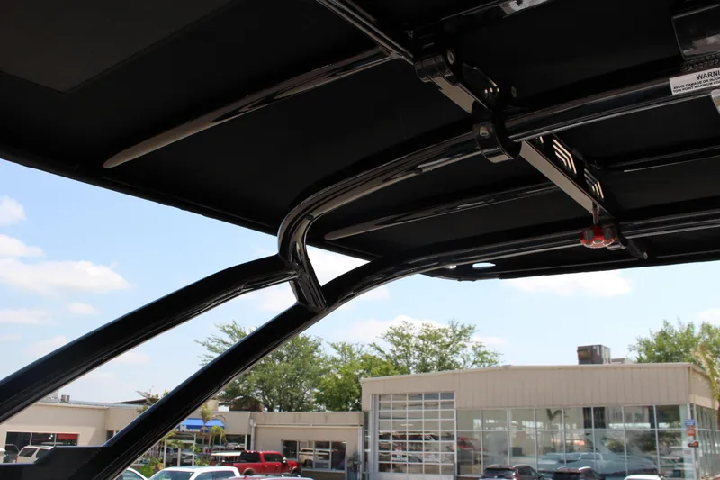 Slide: The Image of 2025 Cobalt R8 boat canopy structure with sleek black frame and outdoor background. - 27