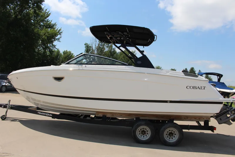 Slide: The Image of 2025 Cobalt R8 boat on trailer, sleek design, parked outdoors under blue sky. - 3