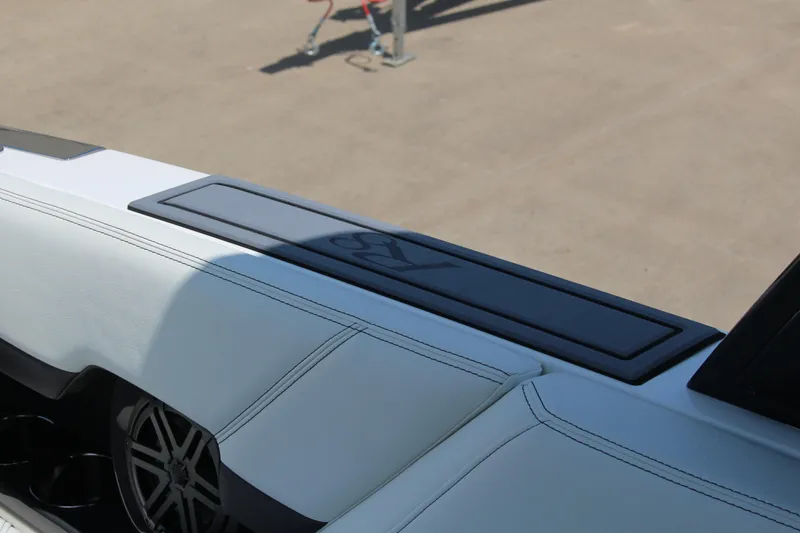 Slide: The Image of 2025 Cobalt R8 boat interior with sleek white seating and modern speaker design. - 31