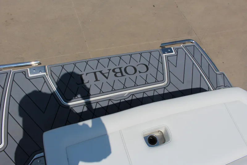 Slide: The Image of 2025 Cobalt R8 boat deck with logo and shadow on textured surface. - 35