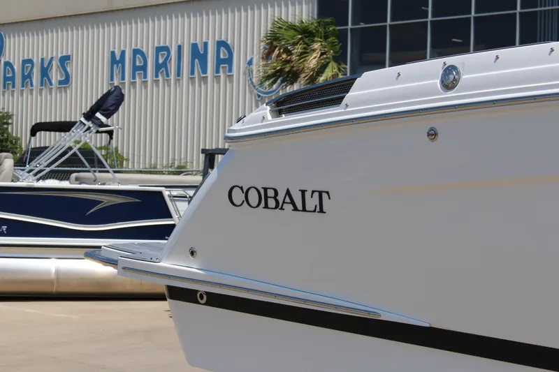 Slide: The Image of 2025 Cobalt R8 boat at marina, showcasing sleek design and branding. - 36