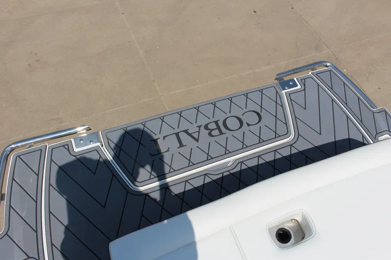 Slide: The Image of 2025 Cobalt R8 boat deck with logo and shadow on textured surface. - 40
