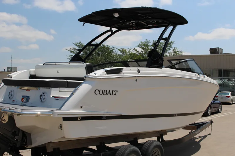 Slide: The Image of 2025 Cobalt R8 boat on trailer, sleek design, white exterior, outdoor setting. - 6