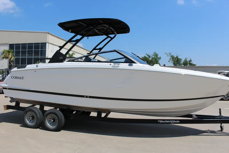 Slide: The Image of 2025 Cobalt R8 boat on trailer, sleek design, white exterior, parked outdoors. - 7