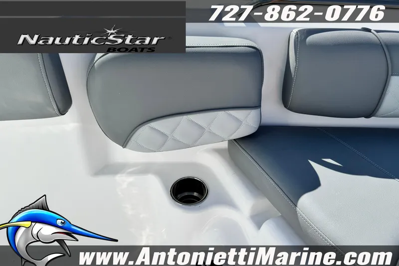 Slide: The Image of 2026 NauticStar 251 Hybrid boat interior with gray seating and cup holder. - 16
