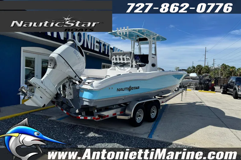 Slide: The Image of 2026 NauticStar 251 Hybrid boat on trailer at Antonietti Marine dealership. - 2