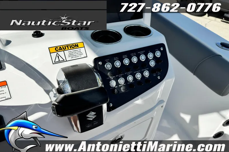 Slide: The Image of 2026 NauticStar 251 Hybrid boat dashboard with controls and caution labels. - 22