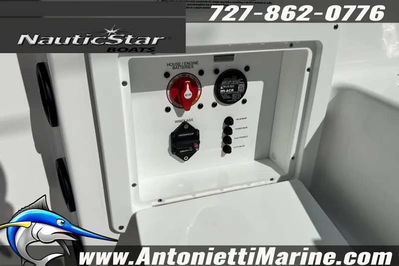 Slide: The Image of 2026 NauticStar 251 Hybrid boat control panel with battery switches and marine electronics. - 25