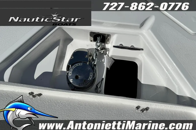 Slide: The Image of 2026 NauticStar 251 Hybrid boat anchor compartment with contact details and logo. - 37