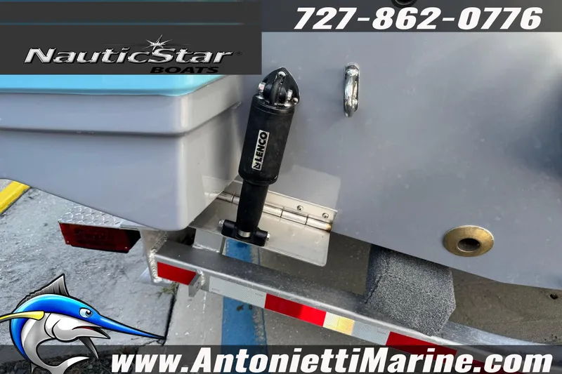 Slide: The Image of NauticStar 251 Hybrid 2026 boat on trailer, featuring Lenco trim tab. - 7
