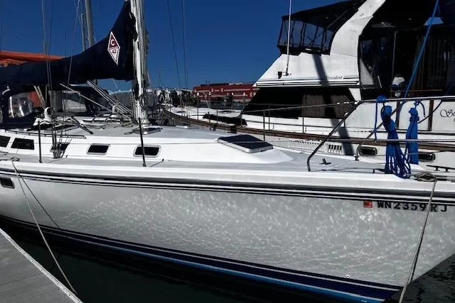 Slide: The Image of 1992 Catalina 42' MkII sailboat docked at marina under clear blue sky. - 0
