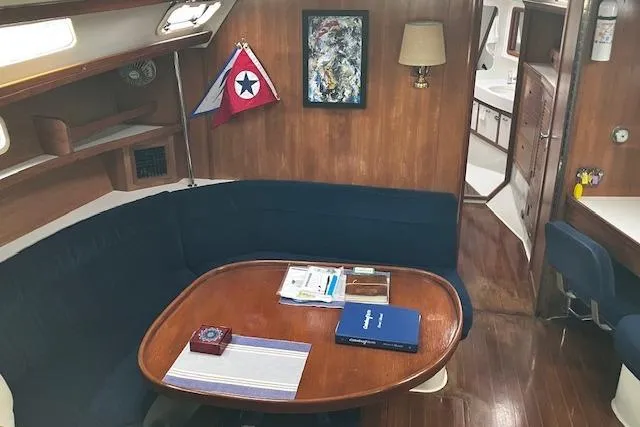 Slide: The Image of Interior of 1992 Catalina 42' MkII sailboat with cozy dining area and nautical decor. - 11