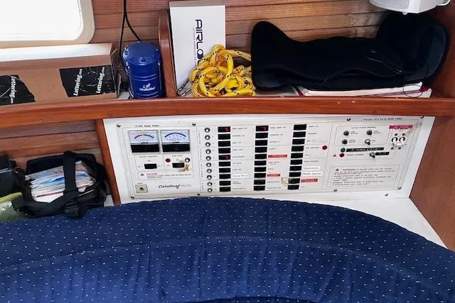 Slide: The Image of Electrical panel and storage area inside a 1992 Catalina 42' MkII sailboat cabin. - 12
