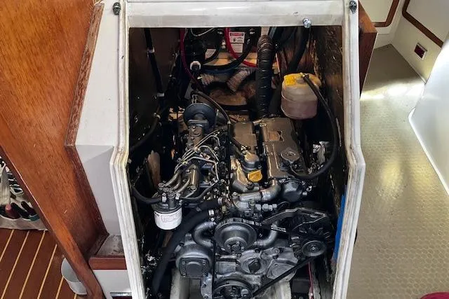 Slide: The Image of Engine compartment of a 1992 Catalina 42' MkII sailboat, showcasing mechanical components. - 19