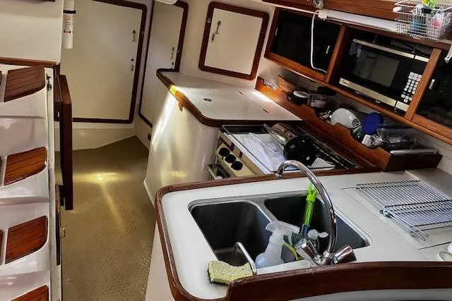 Slide: The Image of Interior of a 1992 Catalina 42' MkII sailboat, featuring a compact kitchen area. - 7