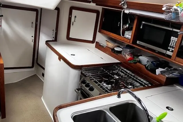 Slide: The Image of Interior of a 1992 Catalina 42' MkII yacht kitchen with stove and sink. - 8