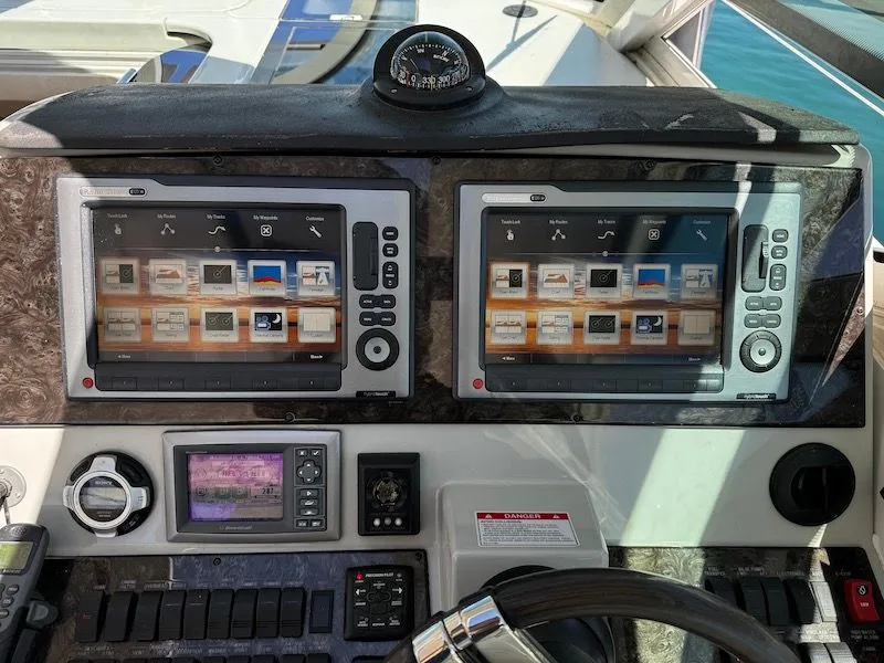 Slide: The Image of 2010 Sea Ray 470 Sundancer on calm waters with coastal backdrop. - 12