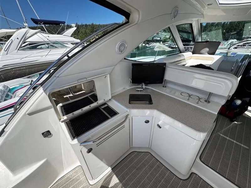 Slide: The Image of 2010 Sea Ray 470 Sundancer yacht near coastal town. - 5
