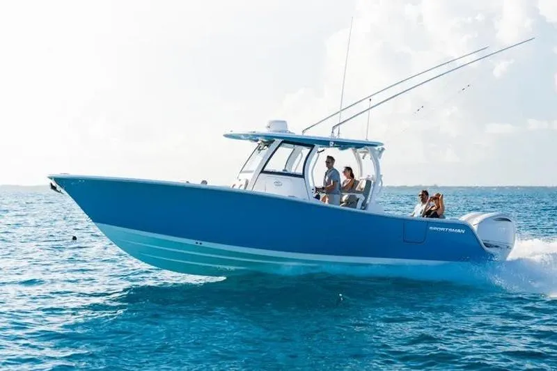 The Image of 2026 Sportsman Open 302 Center Console boat cruising on clear blue ocean waters. - 0